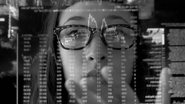 A woman concentrating on a touch screen display.